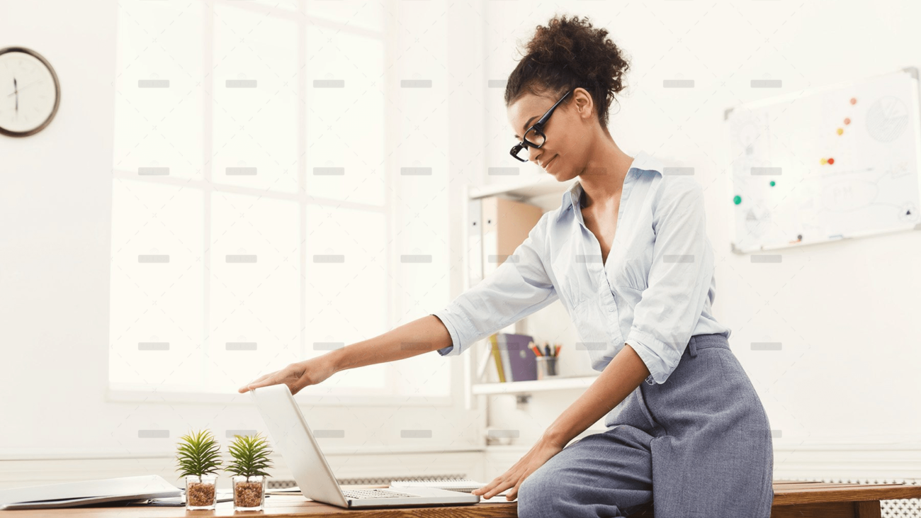 demo-attachment-505-business-woman-opening-laptop-at-office-PU4ZAGW